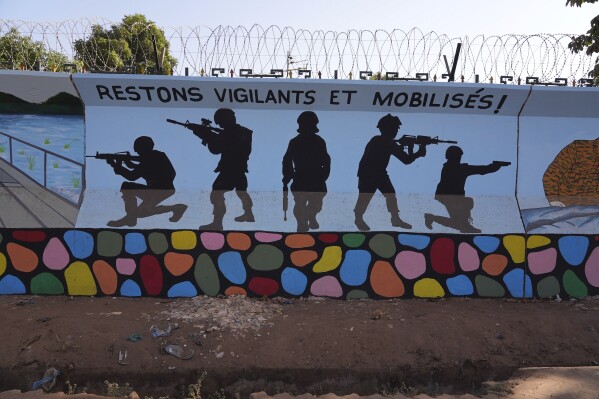 FILE - A mural is seen in Ouagadougou, Burkina Faso, Wednesday March 1, 2023. Three survivors of an attack in Zaongo, central Burkina Faso, told AP that dozens of people were killed in their village on Nov. 5 when security forces attacked. One of the survivors, a 32-year-old farmer, said he photographed the horrific scenes of bodies as proof of the carnage before fleeing. (AP Photo, File)