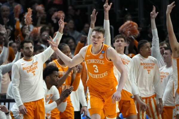 FILE - Tennessee guard Dalton Knecht (3) reacts after a three-point basket during the second half of an Elite Eight college basketball game against Purdue in the NCAA Tournament, Sunday, March 31, 2024, in Detroit. Knecht has always carried a chip on his shoulder with him throughout his cross-country, multi-school basketball journey. he most recent Associated Press mock draft projects him going to the Memphis Grizzlies at No. 9. (AP Photo/Paul Sancya, File)