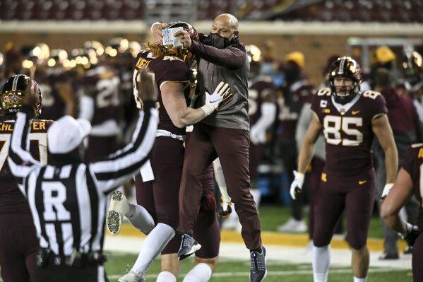 FILE - In this Saturday, Oct. 24, 2020, file photo, Minnesota head coach P.J. Fleck celebrates a touchdown by tight end Ko Kieft (42) in the first half of an NCAA college football game against Michigan, in Minneapolis. Fleck has never lacked for clever ways to connect and motivate his players. (Aaron Lavinsky/Star Tribune via AP, File)