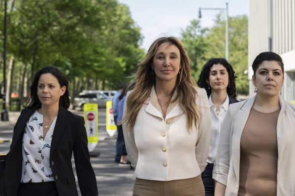 Nicole Daedone, center, founder and former CEO of OneTaste, departs Brooklyn federal court on Tuesday, June 13, 2023 in New York. (AP Photo/Jeenah Moon, File)