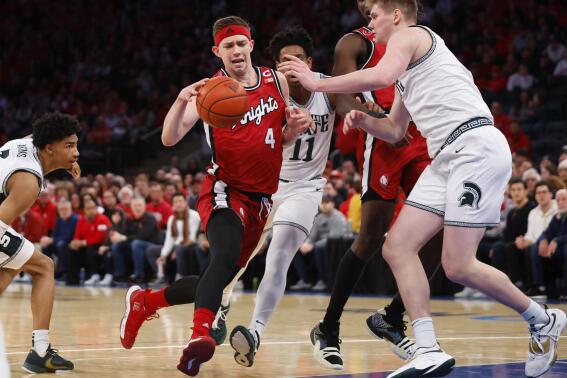 Rutgers guard Paul Mulcahy (4) drives to the basket against Michigan State forward Jaxon Kohler (0) during the first half of an NCAA college basketball game in New York, Saturday, Feb. 4, 2023. (AP Photo/Noah K. Murray)