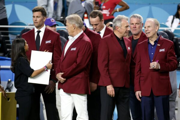 Tom Brady, John Elway, stands with Peyton Manning, Joe Montana, Brett Favre and Roger Staubach, from left, before the NFL Super Bowl 54 football game between the San Francisco 49ers and Kansas City Chiefs Sunday, Feb. 2, 2020, in Miami Gardens, Fla. (AP Photo/Mark Humphrey)