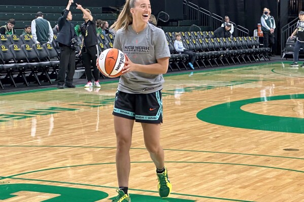 New York Liberty guard Sabrina Ionescu laughs during warmups before a preseason WNBA basketball game against the Toyota Antelopes, of Japan, in Eugene, Oregon, Monday, May 12, 2025. (AP Photo/Anne M. Peterson).
