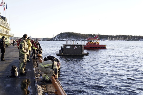A car is retrieved from the water after driving out into the Oslofjord, in Oslo, Norway, Thursday Feb. 1, 2024. (Hakon Mosvold Larsen/NTB Scanpix via AP)