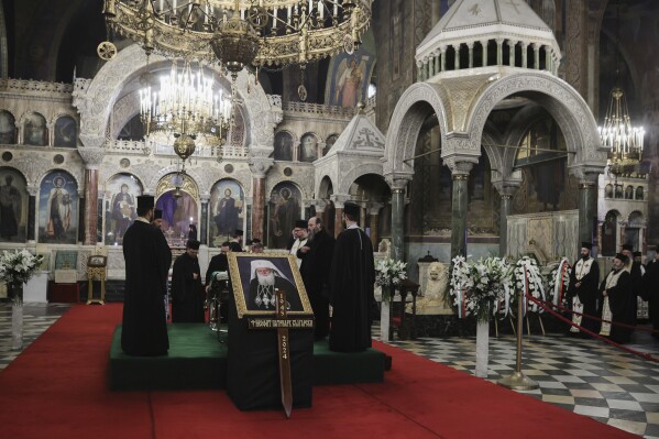 Bulgarian Orthodox Priests pay their last respects to Bulgarian patriarch Neophyte at the Alexander Nevsky Cathedral in Sofia, Friday, March 15, 2024. National mourning was declared by the Bulgarian government on March 15 and 16 to honour Patriarch Neophyte of Bulgaria. Neophyte who was the first elected head of the Orthodox Church in the post-communist Balkan country, died at a hospital in Sofia on March 13. He was 78. .(AP Photo/Valentina Petrova)