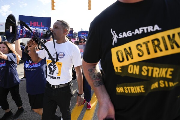 Actor Hill Harper, a democrat running for Michigan's open U.S. Senate seat, walks with SAG-AFTRA members in the Labor Day parade in Detroit, Monday, Sept. 4, 2023. (AP Photo/Paul Sancya)