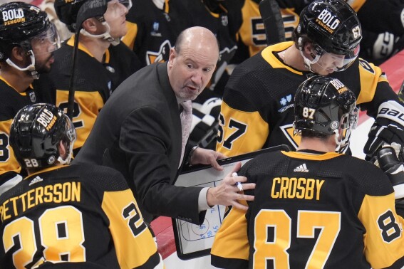 FILE - Pittsburgh Penguins assistant coach Todd Reirden, center, gives instructions during the third period of an NHL hockey game against the Buffalo Sabres, Saturday, Jan. 6, 2024 in Pittsburgh. The Pittsburgh Penguins fired assistant coach Todd Reirden on Friday, May 3, 2024, just over two weeks after the organization missed out on the playoffs for a second straight season. (AP Photo/Gene J. Puskar, File)