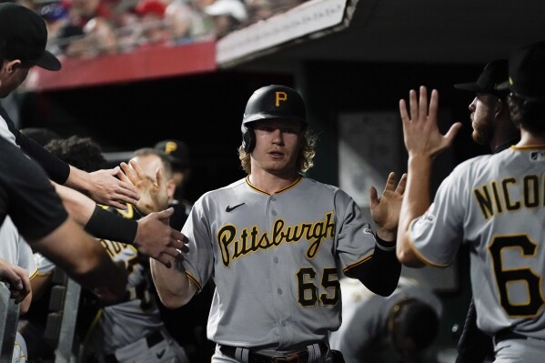 Pittsburgh Pirates' Jack Suwinski is congratulated after scoring against the Cincinnati Reds during the fourth inning of a baseball game Saturday, Sept. 23, 2023, in Cincinnati. (AP Photo/Joshua A. Bickel)