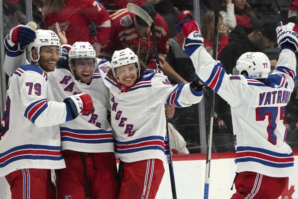 New York Rangers center Andrew Copp, second from left, celebrates his goal in overtime during an NHL hockey game against the Detroit Red Wings Wednesday, March 30, 2022, in Detroit. The Rangers won 5-4. (AP Photo/Paul Sancya)