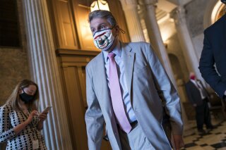 Sen. Joe Manchin, D-W.Va., leaves the Senate chamber following a procedural vote on the nomination of Xavier Becerra, President Joe Biden's pick to be Secretary of Health and Human Services, at the Capitol in Washington, Thursday, March 11, 2021. (AP Photo/J. Scott Applewhite)