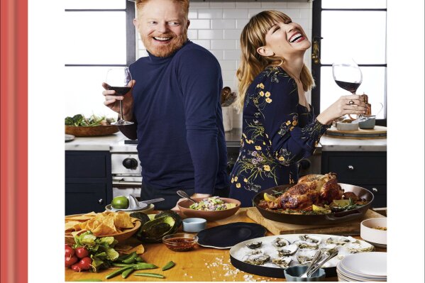 This cover image shows "Food Between Friends" by Jesse Tyler Ferguson and Julie Tanous. (Clarkson Potter via AP)