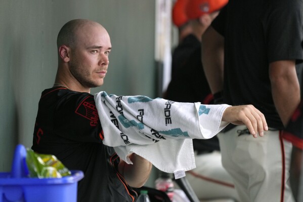 San Francisco Giants pitcher Daulton Jefferies pauses in the dugout after pitching against the Seattle Mariners during the fifth inning of a spring training baseball game Tuesday, Feb. 27, 2024, in Scottsdale, Ariz. Jefferies is trying to come back from a second Tommy John surgery at age 28. (AP Photo/Ross D. Franklin)