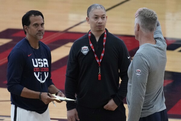 FILE - From left, coaches Erik Spoelstra of the Miami Heat, Tyronn Lue of the Los Angeles Clippers and Steve Kerr of the Golden State Warriors speak at a practice during training camp for the United States men's basketball team Thursday, Aug. 3, 2023, in Las Vegas. Lue was supposed to play for his country in 1997, before an injury left him flying home from Australia alone and unable to be part of the FIBA 22 & Under World Championship. He’s finally wearing the red, white and blue again, as an assistant coach under Steve Kerr for this year’s U.S. World Cup team. (AP Photo/John Locher, File)