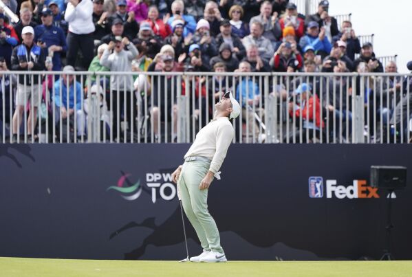 Rory McIlroy celebrates completing his round on day four of the Genesis Scottish Open 2023 golf tournament at The Renaissance Club, North Berwick, Britain, Sunday, July 16, 2023. (Jane Barlow/PA via AP)