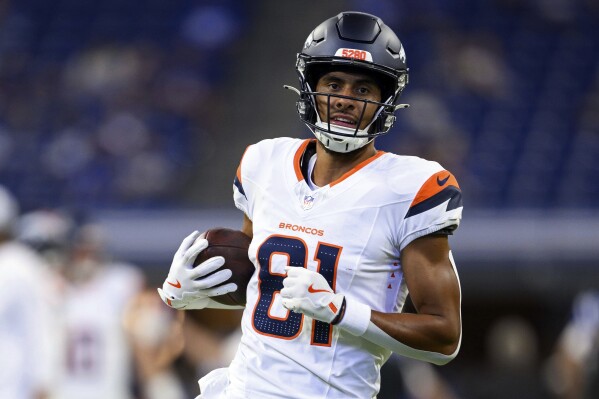 FILE - Denver Broncos wide receiver Devaughn Vele (81) warms before an NFL football game against the Indianapolis Colts, Sunday, Aug. 11, 2024, in Indianapolis. (AP Photo/Zach Bolinger, File)