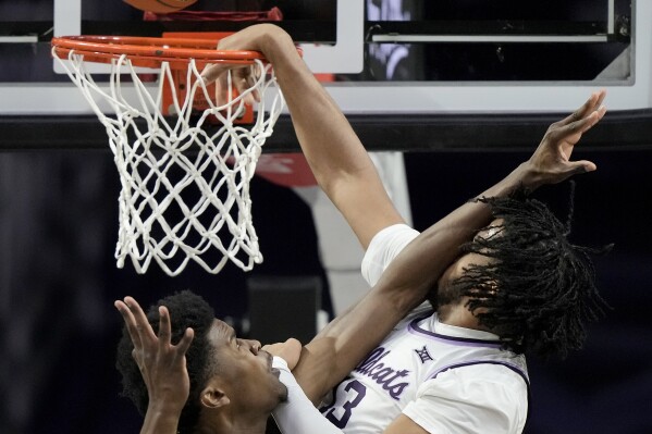 Kansas State forward Will McNair Jr., right, is fouled by Baylor center Yves Missi during the first half of an NCAA college basketball game Tuesday, Jan. 16, 2024, in Manhattan, Kan. (AP Photo/Charlie Riedel)