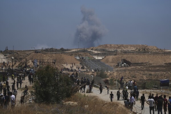 Smoke rises following an Israeli bombardment in southern Gaza, as seen from a humanitarian aid distribution center operated by the U.S.-backed Gaza Humanitarian Foundation, approved by Israel, in Khan Younis, southern Gaza Strip, on Thursday, May 29, 2025. (AP Photo/Abdel Kareem Hana)