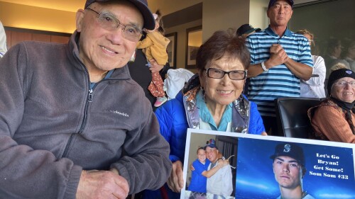 The grandparents of Seattle Mariners rookie pitcher Bryan Woo pose for a photo in San Francisco during a baseball game between the Mariners and the San Francisco Giants, Monday, July 3, 2023. John, 93, left, and Nancy, 85, front right, are from El Cerrito, Calif., and are getting to see their grandson pitch back home in the Bay Area where he grew up in Alameda. (AP Photo/Janie McCauley)