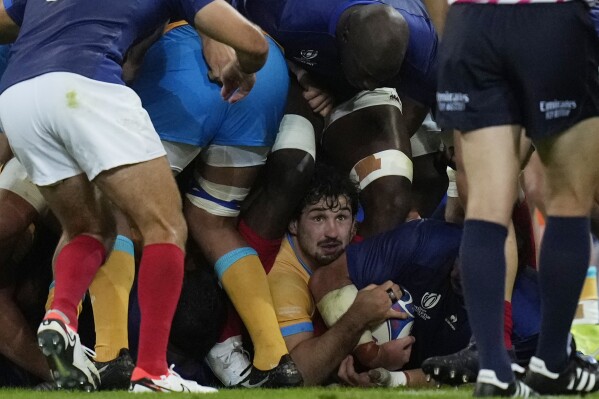Uruguay's Manuel Ardao, centre bottom, fights for the ball during the Rugby World Cup Pool A match between France and Uruguay at the Pierre Mauroy stadium in Villeneuve-d'Ascq, near Lille, France, Thursday, Sept. 14, 2023. (AP Photo/Thibault Camus)