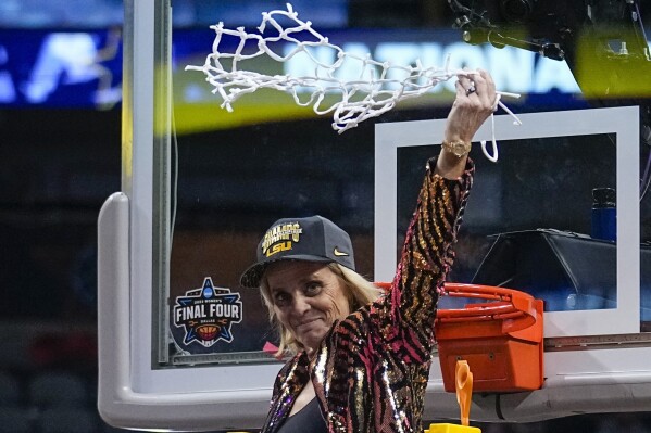 FILE - LSU head coach Kim Mulkey celebrates after cutting down the net after the NCAA Women's Final Four championship basketball game against Iowa, Sunday, April 2, 2023, in Dallas. Mulkey has agreed to a new 10-year contract worth about $32 million that will make her the highest-paid coach in women's college basketball, according to a person with knowledge of the deal.(AP Photo/Tony Gutierrez, File)