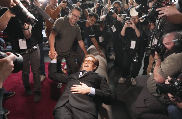 Conan O'Brien, host of Sunday's 97th Academy Awards, poses atop the red carpet during the annual red carpet roll out at the Dolby Theatre on Wednesday, Feb. 26, 2025, in Los Angeles. (AP Photo/Chris Pizzello)