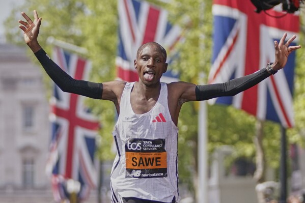 Sabastian Sawe of Kenya reacts after he crossed the line to win the men's race at the London Marathon, Sunday, April 27, 2025. (AP Photo/Alberto Pezzali)