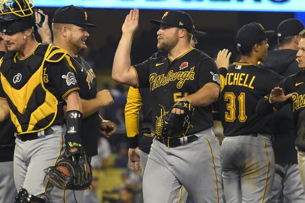 Pittsburgh Pirates relief pitcher David Bednar, center, celebrates with his teammates after defeating the Los Angeles Dodgers 6-5 in a baseball game Monday, May 30, 2022, in Los Angeles. (AP Photo/John McCoy)