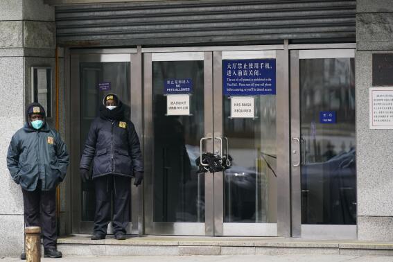 Guards stand outside of the Chinese consulate in New York, on March 28, 2022. Some of China's state media reporters are identifying as travel bloggers and lifestyle influencers on U.S.-owned social media platforms such as Instagram, Facebook and YouTube, racking up millions of followers from around the globe. The Associated Press has identified dozens of these accounts, which are part of a network of profiles that allow China to easily peddle propaganda to unsuspecting social media users.  (AP Photo/Seth Wenig)