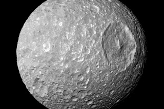 This Feb. 13, 2010 image provided by NASA shows Saturn's moon Mimas and it's large Herschel Crater, captured by the Cassini spacecraft. The crater is 130 kilometers (80 miles) wide. Astronomers have reported the best evidence yet of a vast, relatively new ocean beneath the icy exterior of Mimas, believed between 5 million and 15 million years old. The findings were published Wednesday, Feb. 7, 2024, in the journal Nature. (NASA/JPL-Caltech/Space Science Institute via AP)