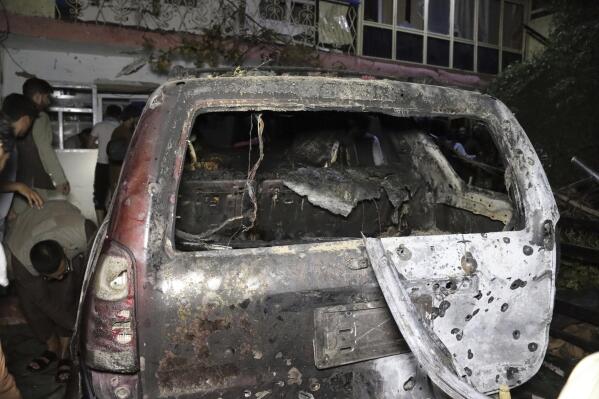 A destroyed vehicle is seen inside a house after a U.S. drone strike in Kabul, Afghanistan, Sunday, Aug. 29, 2021. A U.S. drone strike destroyed a vehicle carrying "multiple suicide bombers" from Afghanistan's Islamic State affiliate on Sunday before they could attack the ongoing military evacuation at Kabul's international airport, American officials said. (AP Photo/Khwaja Tawfiq Sediqi)