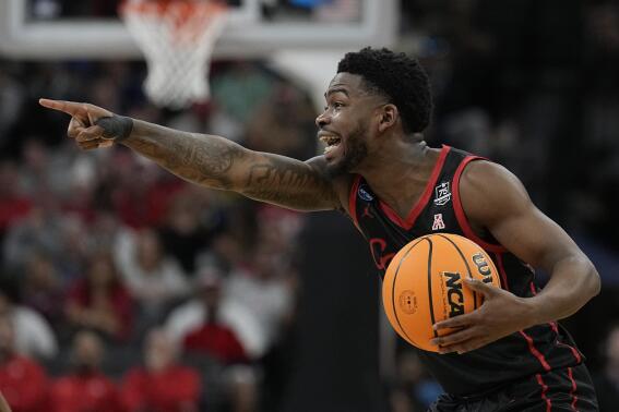 Houston guard Jamal Shead yells during the first half of a college basketball game against Arizona in the Sweet 16 round of the NCAA tournament on Thursday, March 24, 2022, in San Antonio. (AP Photo/Eric Gay)
