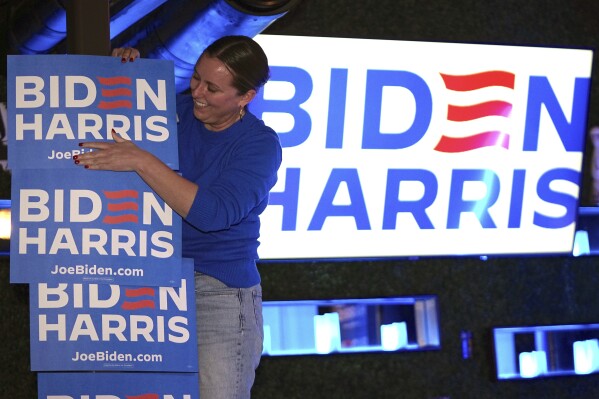 Campaign team member Chelsey Wininger helps decorate at the Biden-Harris for Nevada team first-in-the-West celebration, Tuesday, Feb. 6, 2024, in Las Vegas. (AP Photo/Mark J. Terrill)