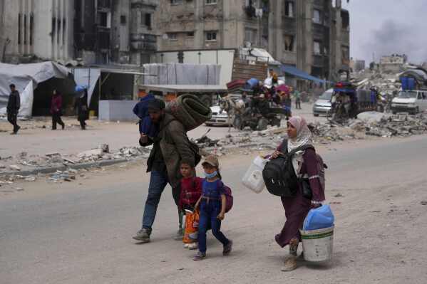 Displaced Palestinians fleeing Beit Lahia amid ongoing Israeli military operations in the Gaza Strip arrive in Jabalia, northern Gaza, on Sunday, May 18, 2025. (AP Photo/Jehad Alshrafi)