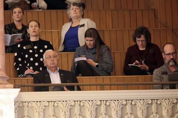 In this photo from Wednesday, March 27, 2024, three anti-abortion lobbyists sit in the second row of the main Kansas House gallery, monitoring its debates and votes, at the Statehouse in Topeka, Kan. They are, left to right, Lucrecia Nold, of the Kansas Catholic Conference; Brittany Jones, of the Kansas Family Voice and Jeanne Gawdun, of Kansans for Life. (AP Photo/John Hanna)