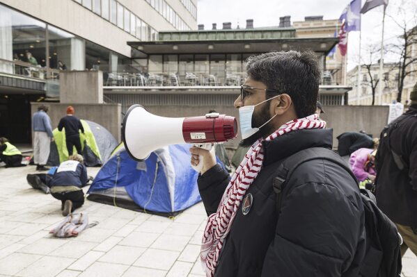 Supporters of Palestinians attend a protest rally outside the Helsinki University in Helsinki, Finland, Monday, May 6, 2024. Demonstrators are demanding boycott against Israeli universities. (Roni Rekomaa/Lehtikuva via AP)