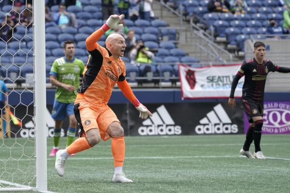 Atlanta United goalkeeper Brad Guzan gestures from the goal during the second half of an MLS soccer match against the Seattle Sounders, Sunday, May 23, 2021, in Seattle. (AP Photo/Ted S. Warren)