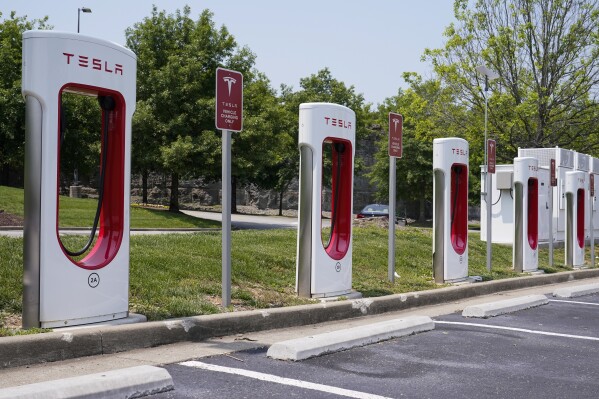 FILE - A Tesla electronic vehicle charging station is seen Thursday, May 25, 2023, in Nashville, Tenn. The Biden administration is making available $20 billion from a federal "green bank" for clean energy projects such as residential heat pumps, electric vehicle charging stations and community cooling centers. (AP Photo/George Walker IV)