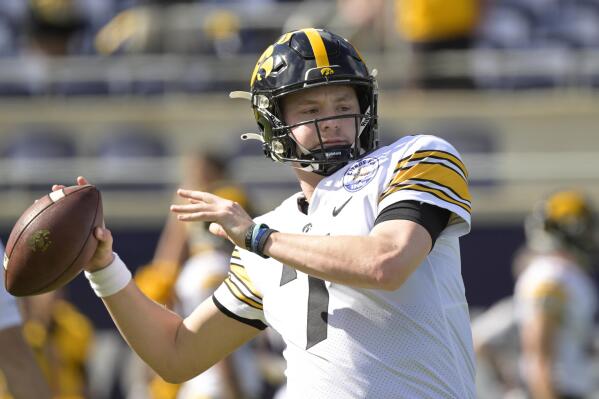FILE - Iowa quarterback Spencer Petras (7) warms up before the Citrus Bowl NCAA college football game against Kentucky, Saturday, Jan. 1, 2022, in Orlando, Fla. The battle this spring is between veteran starter Spencer Petras and Alex Padilla. (AP Photo/Phelan M. Ebenhack, File)