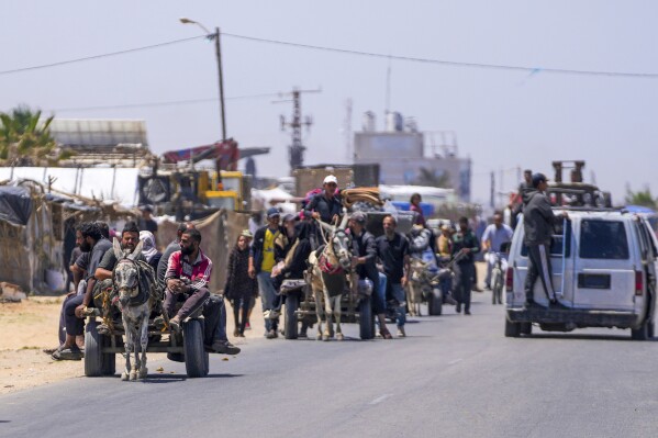 Displaced Palestinians arrive in central Gaza after fleeing from the southern Gaza city of Rafah in Deir al Balah, Gaza Strip, on Thursday, May 9, 2024. (AP Photo/Abdel Kareem Hana)