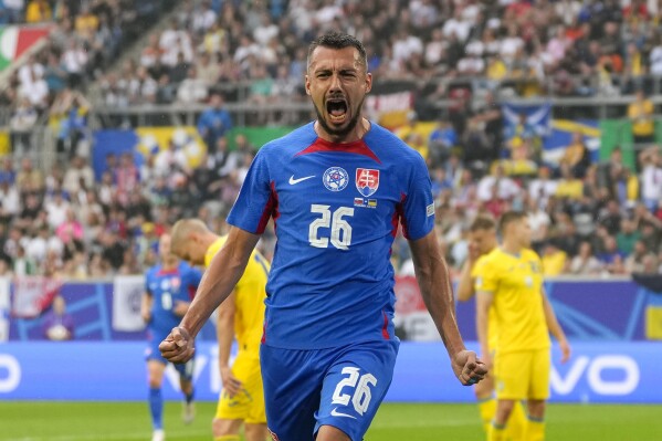  Slovakia's Ivan Schranz celebrates after scoring his side's opening goal during a Group E match between Slovakia and Ukraine at the Euro 2024 soccer tournament in Duesseldorf, Germany, Friday, June 21, 2024. (AP Photo/Andreea Alexandru)