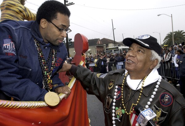 Honorary Grand Marshal Spike Lee stops his float at the start of the Zulu parade to say hello to Tuskogee Airman Judge Robert Decatur, from Titusville, Fla., as the parade starts on Mardi Gras in New Orleans, March 4, 2003. (AP Photo/Alex Brandon, file)