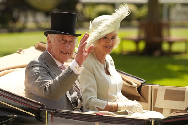 FILE - Britain's King Charles III and Camilla, the Queen Consort arrive in a carriage for Ladies Day of the Royal Ascot horse racing meeting, at Ascot Racecourse in Ascot, England, Thursday, June 22, 2023. King Charles III and Queen Camilla will visit France in September, Buckingham Palace said Thursday, Aug. 24, 2023, after their planned state visit in March was postponed amid widespread demonstrations against President Emmanuel Macron's retirement age reforms. (AP Photo/Alastair Grant, File)