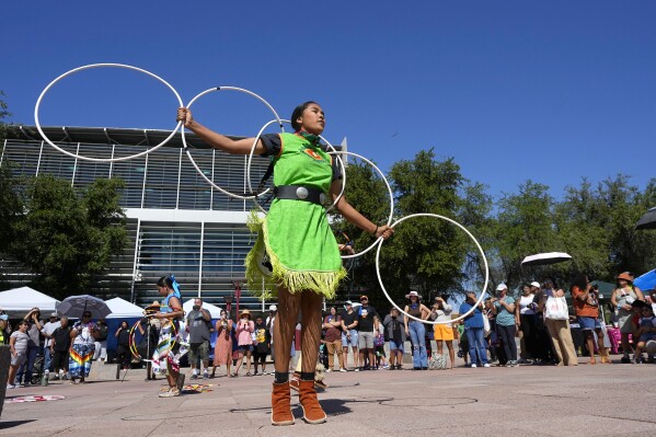 Performers from the Native American Hoop Dance of Ballet Arizona dance at an Indigenous Peoples Day festival Monday, Oct. 9, 2023, in Phoenix. (AP Photo/Ross D. Franklin)