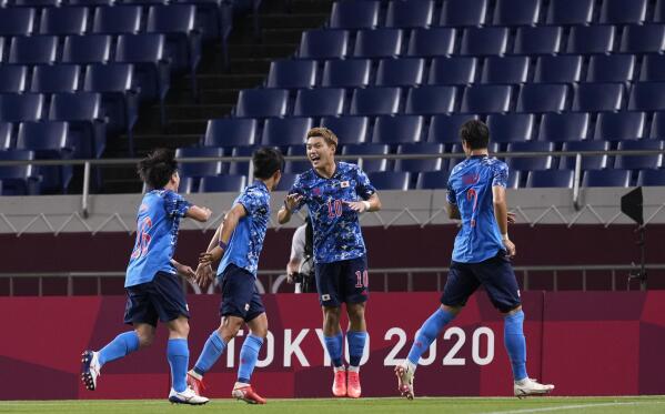 Japan's Ritsu Doan, center, celebrates with teammates after scoring a goal during a men's soccer match against Mexico at the 2020 Summer Olympics, Sunday, July 25, 2021, in Saitama, Japan. (AP Photo/Martin Mejia)