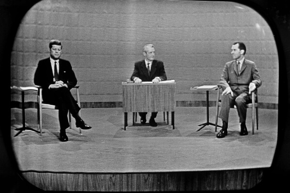 Democrat Sen. John Kennedy, left and Republican Richard Nixon, right, as they debated campaign issues at a Chicago television studio on Sept. 26, 1960. Moderator Howard K. Smith is at desk in center. (AP Photo)