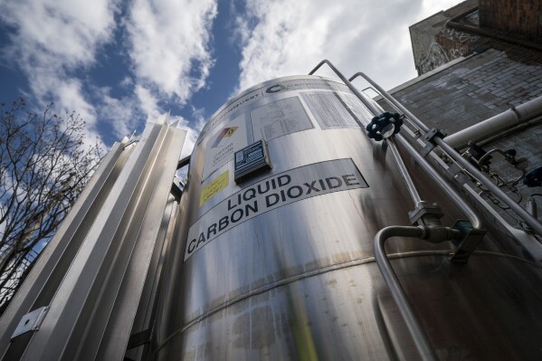 FILE - A liquid carbon dioxide containment unit stands outside the fabrication building of Glenwood Mason Supply Company, April 18, 2023, in the Brooklyn borough of New York. (AP Photo/John Minchillo, File)