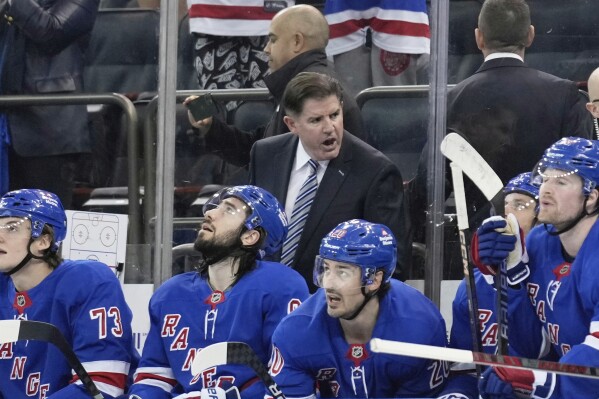 New York Rangers coach Peter Laviolette talks to this team during the second period of an NHL hockey game against the Tampa Bay Lightning in New York, Thursday, April 17, 2025. (AP Photo/Seth Wenig)