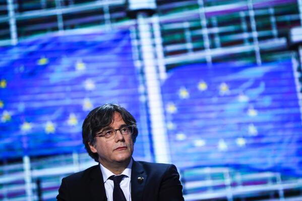 FILE - In this Tuesday, March 9, 2021, file photo, member of European Parliament Carles Puigdemont prepares for an interview at the European Parliament in Brussels. The lawyer for Puigdemont says the former Catalan leader has been detained in Sardinia, Italy. Gonzalo Boye confirmed to the Associated Press that Puigdemont was detained on Thursday, Sept. 23. Boye wrote on Twitter that the former Catalan president, wanted by Spain for his role in an unauthorized referendum for independence, was being held under a European arrest warrant issued by Spain in 2019. (AP Photo/Francisco Seco, File)