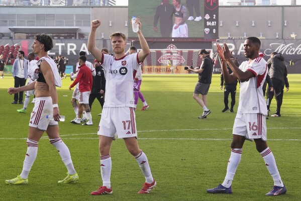 Toronto FC players applaud their fans after defeating D.C. United in an MLS soccer game in Toronto, Saturday, May 10, 2025. (Frank Gunn/The Canadian Press via AP)