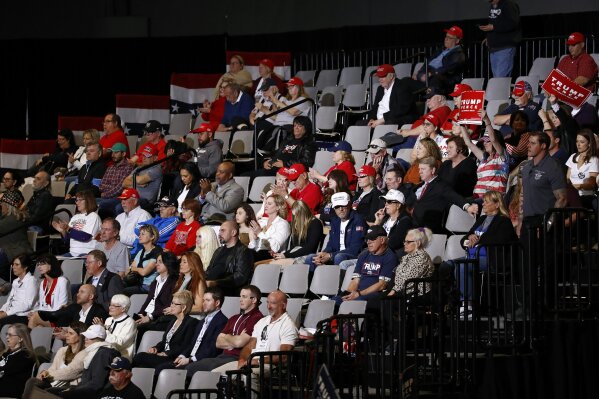 In this Feb. 21, 2020, photo, attendees listen as President Donald Trump speaks during a campaign rally in Las Vegas. The Trump show has a consistent script, with villains, nicknames, grievances and the same hero: himself. At raucous rallies, mostly in states friendly to him, the president tells audiences he could be presidential if he chose to be, even Lincolnesque.  (AP Photo/Patrick Semansky)